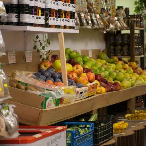 Vibrant fruit display in a Greek market, showcasing apples, bananas, and more.